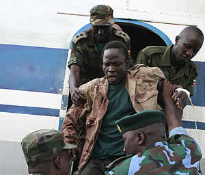Thomas Kwoyelo getting off a plane at Entebbe Airport from Congo where he was capture. New Vision photo