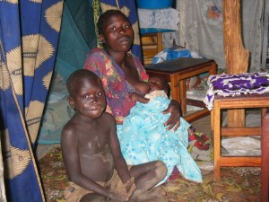 MEDIA 21 053 A woman with her kids in hut at Anaka IDP camp. Rosebell Kagumire photo.
