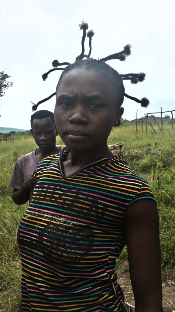 One of the young women I met at the villages in the refugee settlement. She wanted to work on my hair to be this cool. We didn't get time.